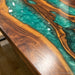 Luxury live edge walnut table featuring a vibrant green epoxy resin river.