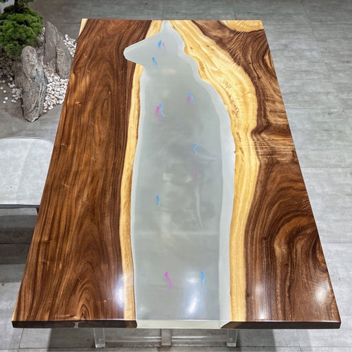 Custom dining table crafted from live edge wood with a translucent resin river centerpiece, combining natural textures with minimalist contemporary style.