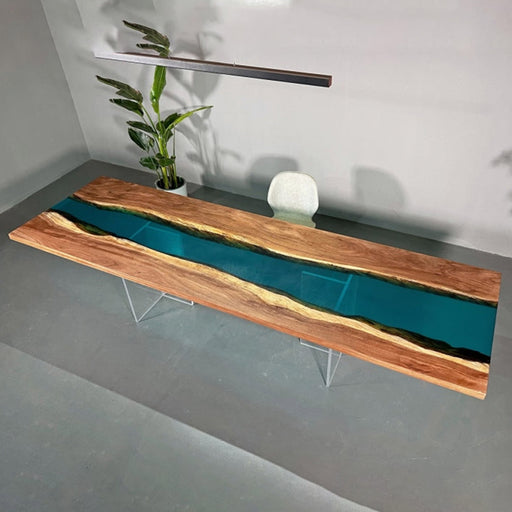 Extra-long epoxy river dining table crafted with live edge walnut wood, featuring a crystal-clear blue resin river for a striking centerpiece design.