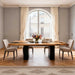 Dining room with a wooden table and chairs in front of large windows.