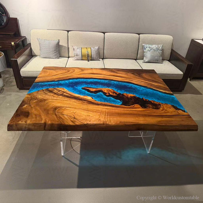 A luminous river table with blue resin, ideal for luxury Malibu home decor.