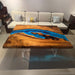 A luminous river table with blue resin, ideal for luxury Malibu home decor.