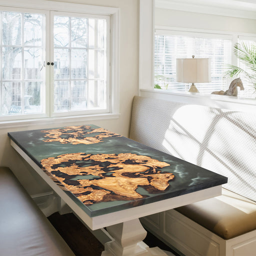 Custom kitchen island table featuring natural burl wood patterns seamlessly embedded in ocean-inspired epoxy resin, showcasing organic textures and contemporary design aesthetics.