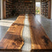 Long wooden table with a river of light design in a library setting