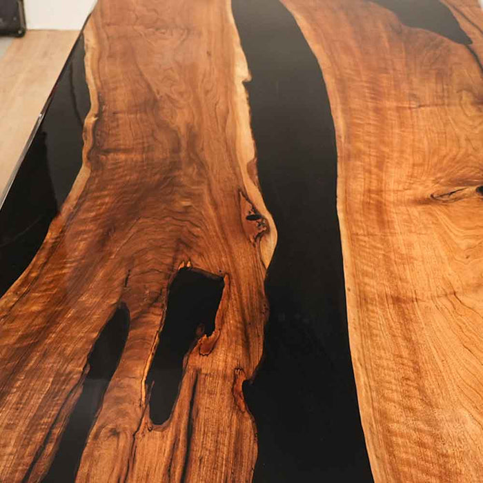 Wooden surface with black resin inlay