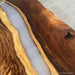 Wooden table with a river of resin design on a gray surface
