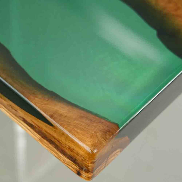 Olive semi-transparent blue wave epoxy resin dining table styled in a modern dining room.