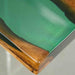 Olive semi-transparent blue wave epoxy resin dining table styled in a modern dining room.