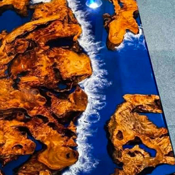 Close-up of a wooden surface with natural patterns and a blue resin finish.