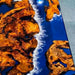 Close-up of a wooden surface with natural patterns and a blue resin finish.