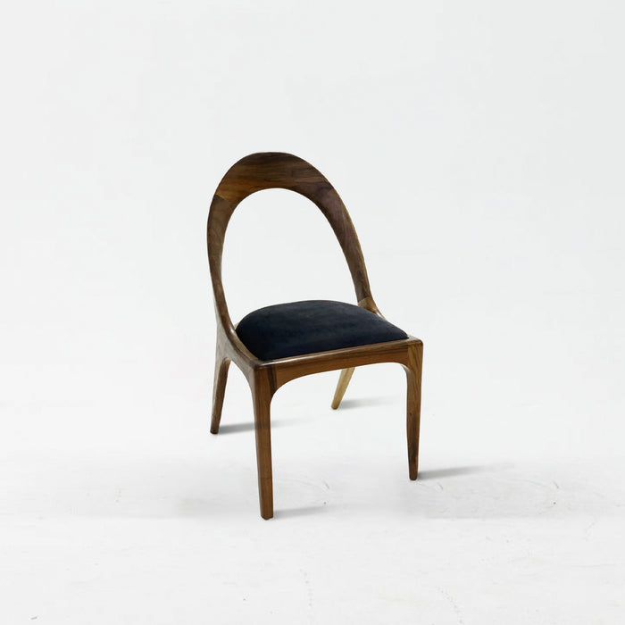 Wooden chair with a black cushion on a white background