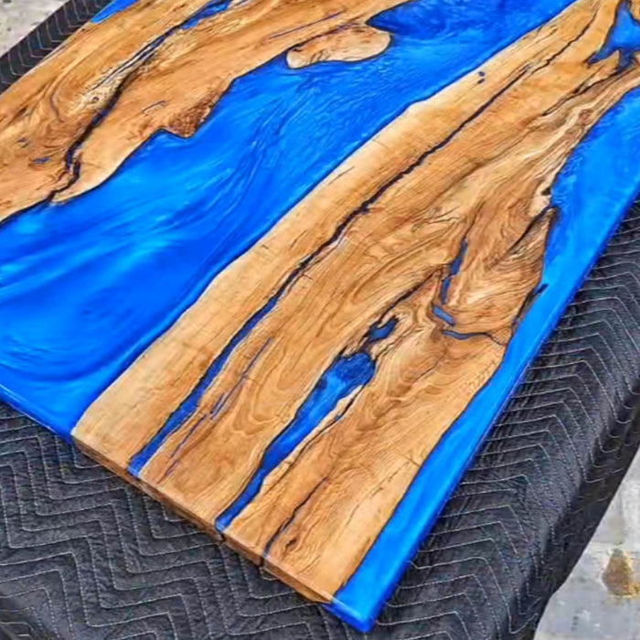 Luxury epoxy resin conference table made from olive wood and blue resin
