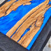 Luxury epoxy resin conference table made from olive wood and blue resin