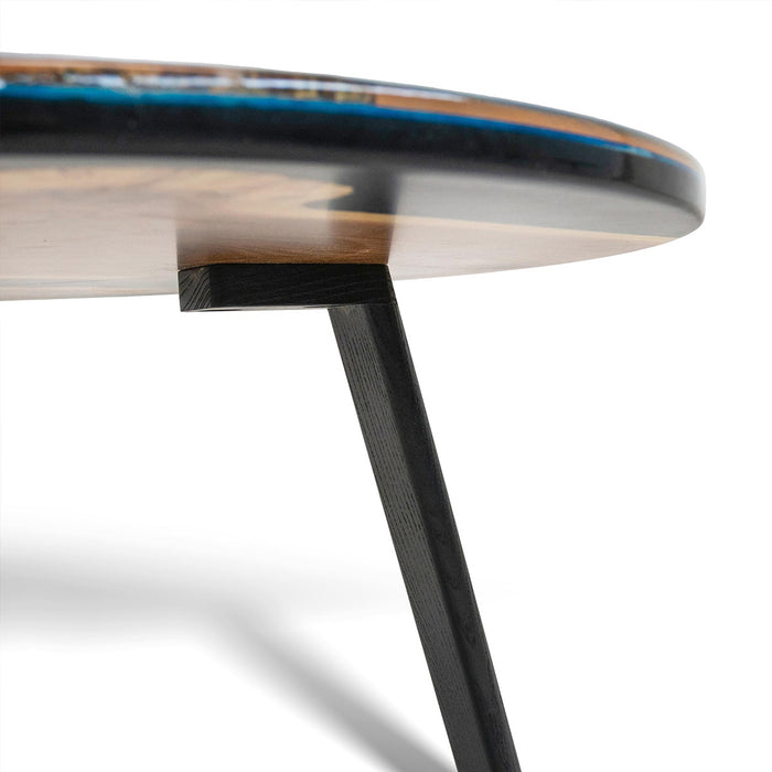 Round wooden table with a black metal leg on a white background