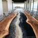 Detailed view of luxury epoxy river table highlighting smooth black resin finish