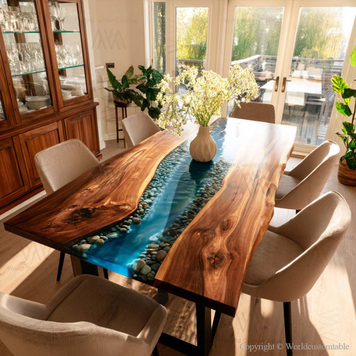 Luxury epoxy river table featuring blue resin river with embedded stones