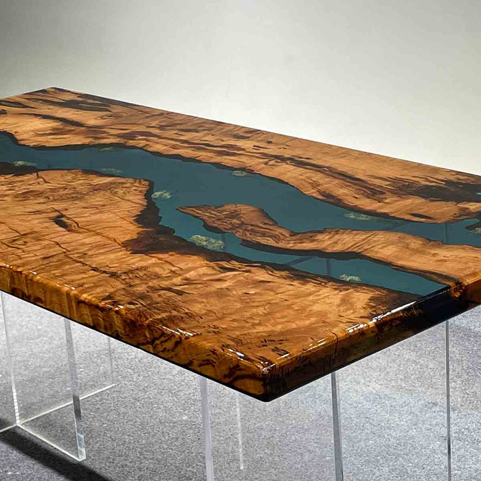 Wooden table with a river design embedded in it, on a gray background