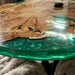 Luxury round coffee table showcasing rare olive burl wood and a high-gloss green epoxy resin finish