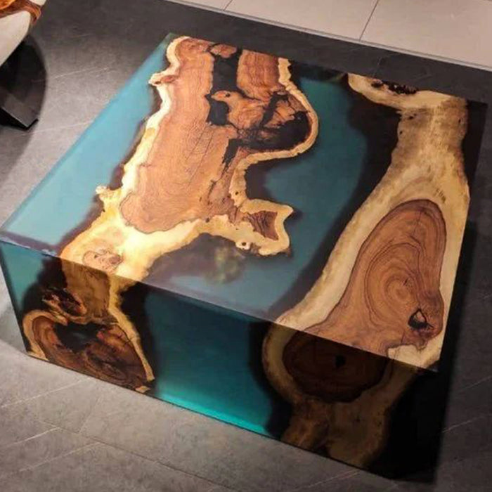 Coffee table with wooden slabs and blue resin on a dark surface