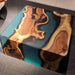 Coffee table with wooden slabs and blue resin on a dark surface