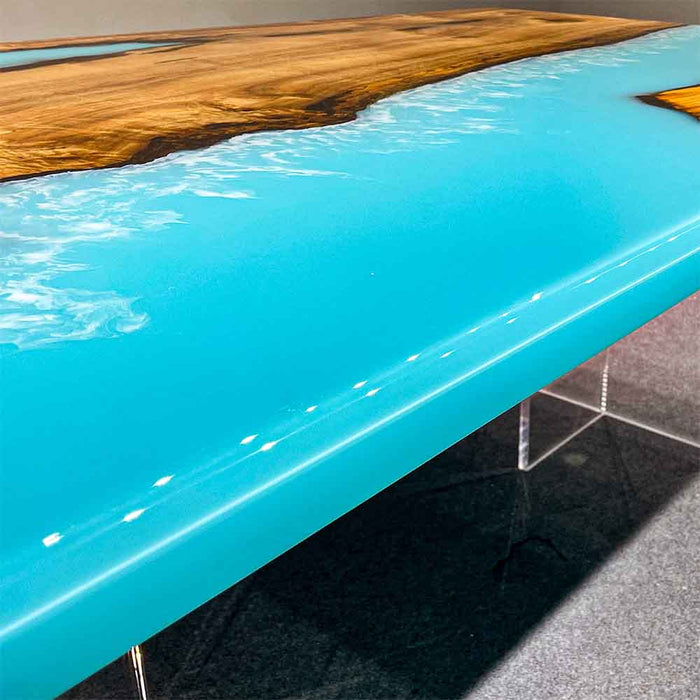 Golden Camphor light blue epoxy resin dining table styled in a contemporary dining room.