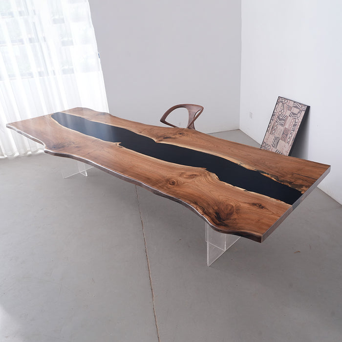 Wooden desk with black resin inlay in a minimalistic room.