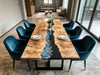 Poplar burl wood dining table with black and blue gradient epoxy river design, set in a modern luxury kitchen.
