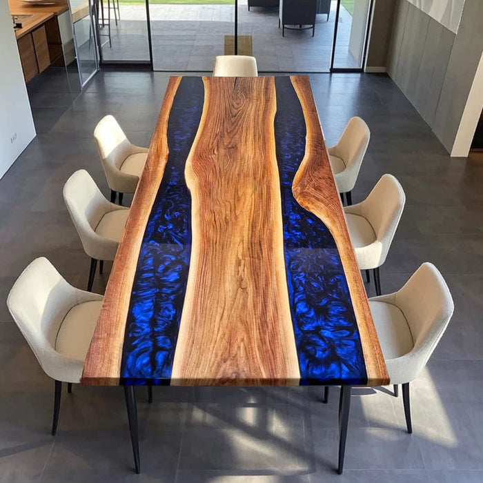 Modern luxury resin table with black walnut slabs and vibrant blue epoxy inlay