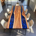 Modern luxury resin table with black walnut slabs and vibrant blue epoxy inlay