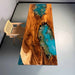 Wooden table with a blue resin inlay in a minimalistic room.