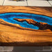 Luxury epoxy river table in walnut, suitable for an outdoor patio or living room.