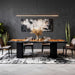 Modern dining room with a dark gray wall, abstract painting, and a marble table.