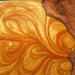 Luxury dining table crafted from live edge walnut slabs and a rich gold epoxy resin river.