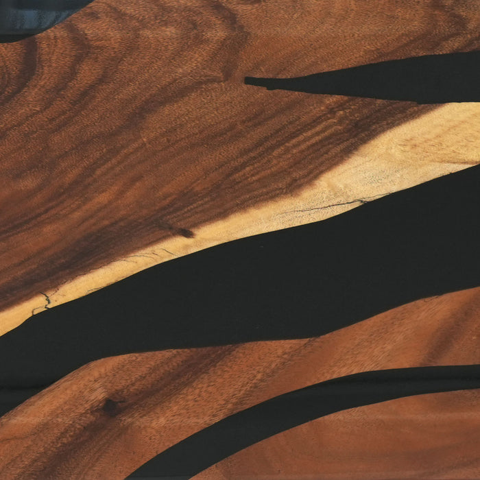 Close-up of a wooden surface with a person's hand casting a shadow