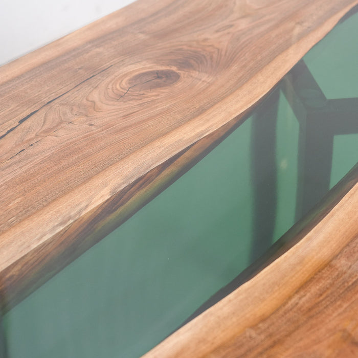 Close-up of a wooden surface with a glass panel