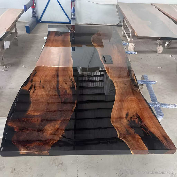 Luxury wood epoxy meeting table featuring natural walnut grain and elegant black resin details