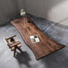 LuxWood handcrafted live edge solid wood table in a minimalist concrete room