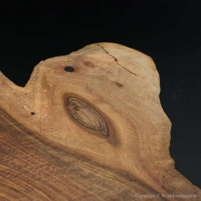 Close-up of a wooden surface with natural grain and texture on a black background