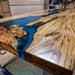 Wooden table with blue resin inlay in a workshop setting
