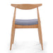 Wooden chair with a blue cushion on a white background