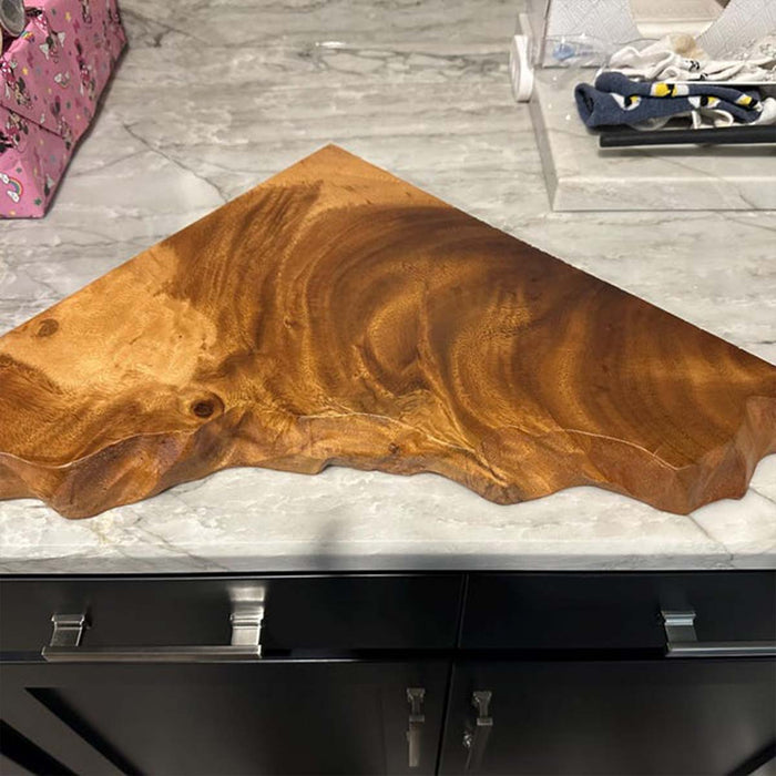 Wooden slab on a kitchen counter with a blurred background