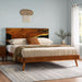 Wooden bed with bedding in a bedroom setting