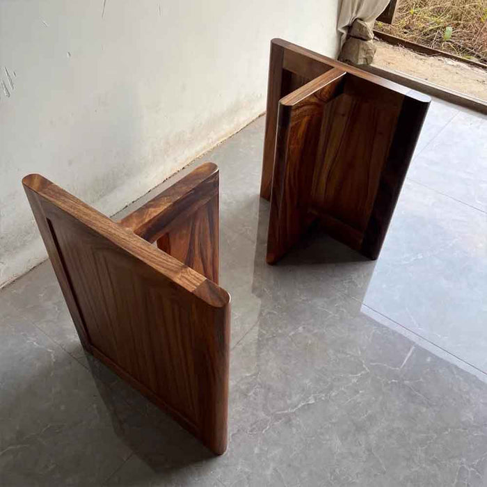 Two wooden stools on a tiled floor with a neutral background