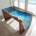 Modern epoxy dining table showcasing a waterfall resin effect.