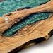 Wooden surface with a central river-like design filled with turquoise resin.
