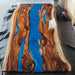 Modern epoxy resin river table featuring natural burl wood and glossy finish