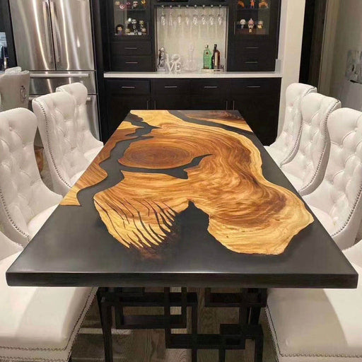 Modern epoxy dining table featuring a striking combination of natural wood grain and smooth black resin in a live edge design, perfectly blending rustic charm with contemporary elegance.