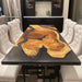 Modern epoxy dining table featuring a striking combination of natural wood grain and smooth black resin in a live edge design, perfectly blending rustic charm with contemporary elegance.