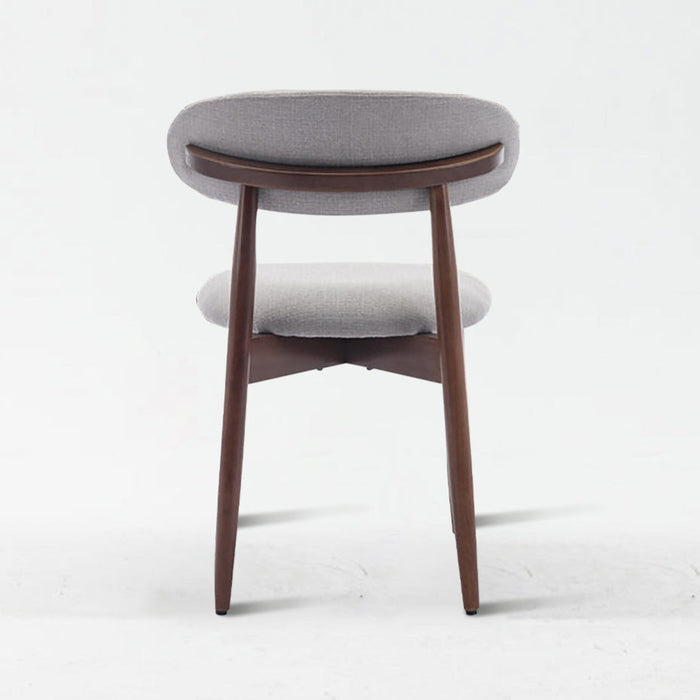 Small round stool with gray cushioned seat and wooden legs on a white background