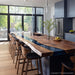 Modern farmhouse dining table handcrafted from walnut wood with coastal navy epoxy finish